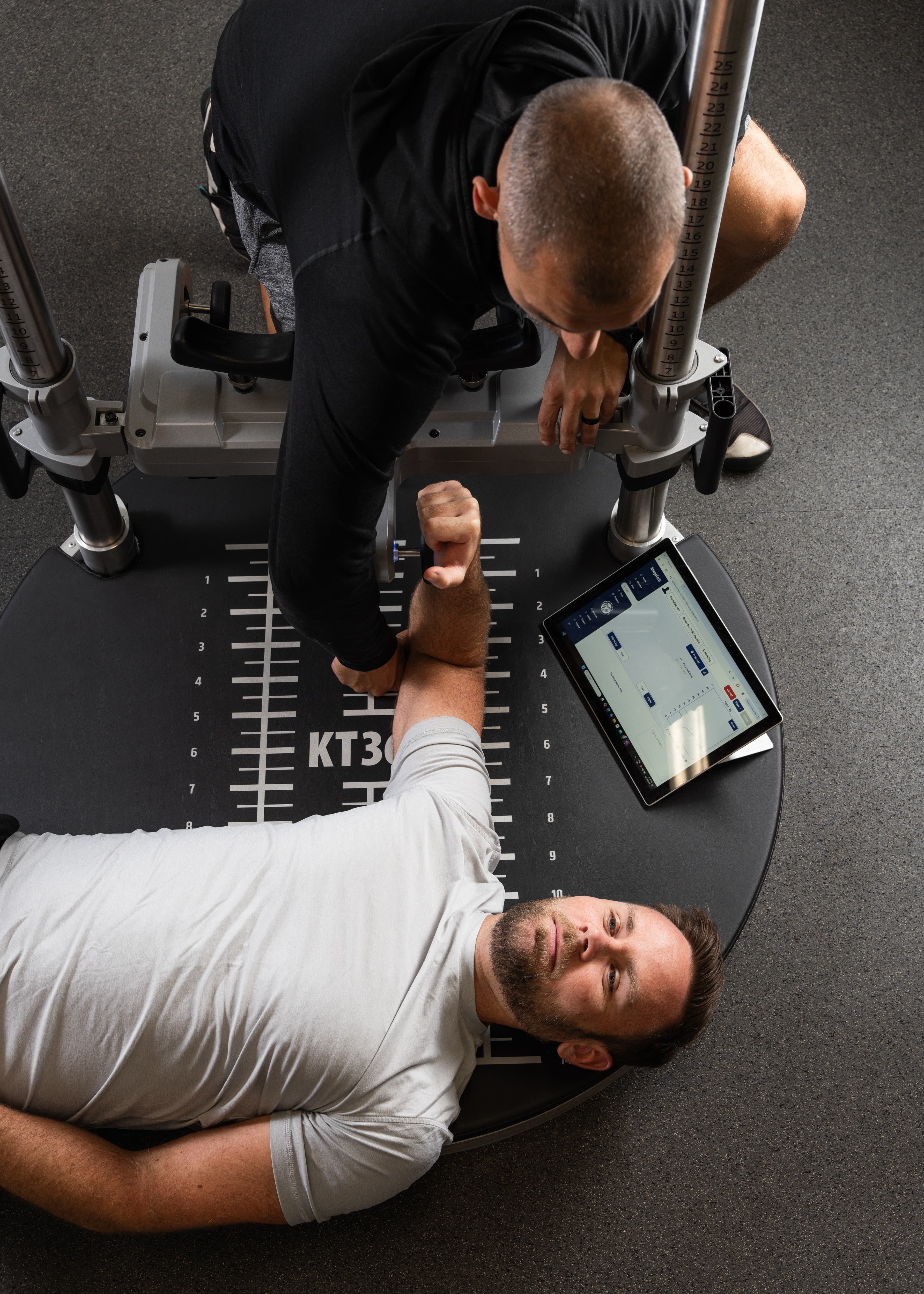 A client performing a strength test on VALD ForceFrame equipment with results displayed on a tablet